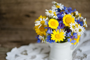 wild flowers on a wooden background