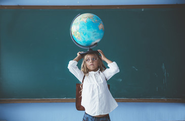 Pupil girl posing with globe