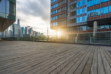 Empty wooden footpath with modern building in Shanghai