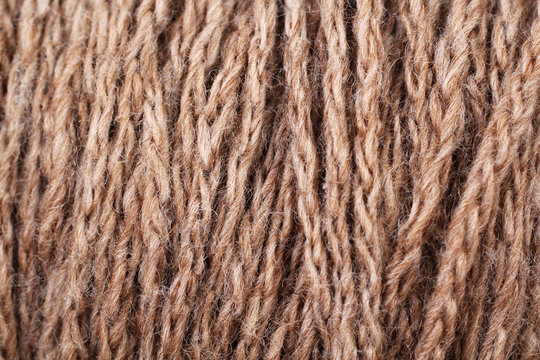 A super close up image of brown yarn