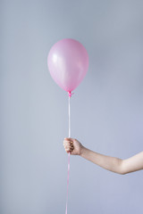 hand holding single pink balloon © gillianvann