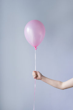 Hand Holding Single Pink Balloon