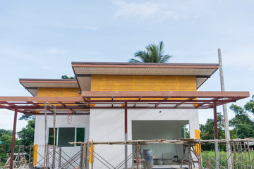 Obraz na płótnie Canvas Building Site With House Under Construction