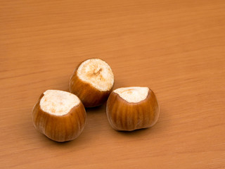 Hazelnuts on a wooden background closeup.