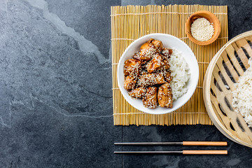 Japanese food. Chicken teriyaki with rice. slate background, top view