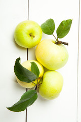 Fresh apples on a white wooden background
