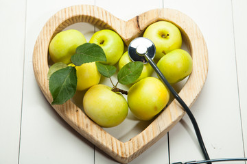 Health. Fresh apples on a white wooden background
