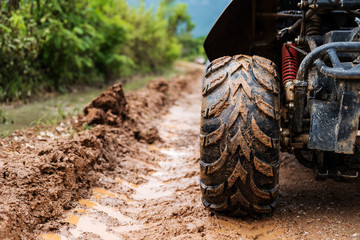 Off road wheel on dirt road in rainy day