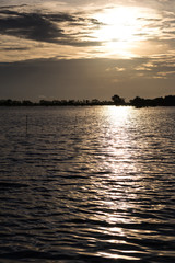 Naklejka premium The backlit wave of water is sparkling early in the morning.