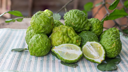 fresh bergamot fruit and bergamot slice in the Wicker basket on wooden background.