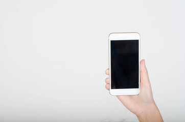 Woman hand holding smartphone with blank screen isolated on white background.