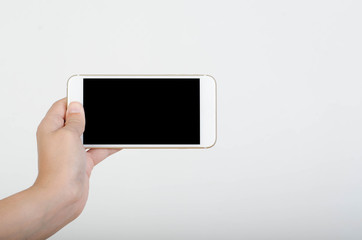 Woman hand holding smartphone with blank screen isolated on white background.