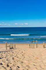 Beach entrance with blue ocean and soft waves