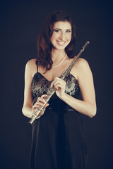 Elegant woman with flute instrument.