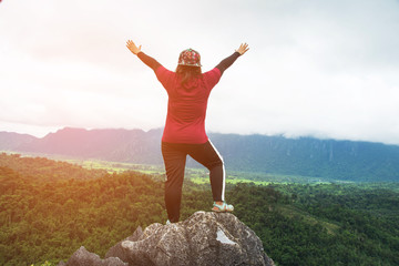 rear hiking woman on top mountain with nature view (Namxay Top View at Laos).