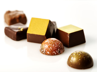 Collection of delicious chocolate pralines isolated on white.