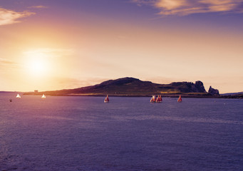 Photo of a beautiful scenic sea landscape. Yachts in sea, view on Howth Harbour Lighthouse, Howth...