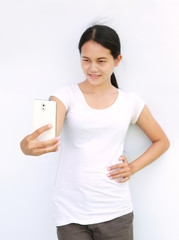 young girl playing smart phone on white background.