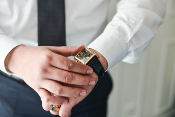 businessman clock clothes, businessman checking time on his wristwatch.