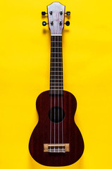 Obraz premium Ukulele on yellow background. Music or arts concept