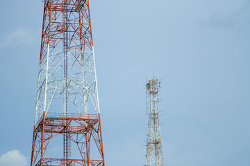 Two signal tower with blue sky.