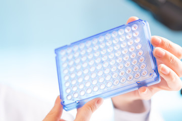 Woman student with pcr devices in medical laboratory