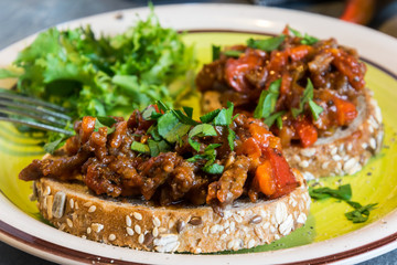 Beef meat mixture with tomatoes and pepper on fried bread, herbaceous. Great dinner