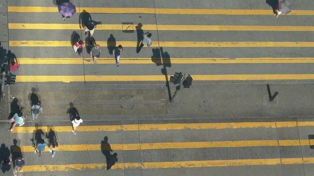 Aerial top view of people on crosswalk. 4K resolution