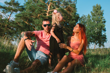 Young family portrait, mother, father and daughter having fun together and hug each other