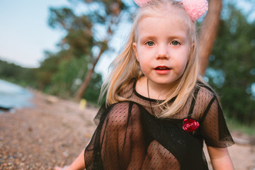 Portrait of child girl with blonde hair and blue eyes 