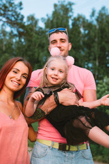 Young family portrait, mother, father and daughter having fun together and hug each other