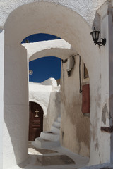 Romantic passage in Cyclades style Megalochori village, Santorini island, Greece