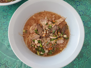 Noodles in a bowl on a table.