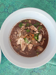 Noodles in a bowl on a table.