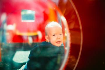 Portrait of a cute child boy with blue eyes, who is starring at the camera and smile.Outdoors healthy child activity, active lifestyle and having fun on family summer vacation with son at the playgrou