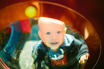 Portrait of a cute child boy with blue eyes, who is starring at the camera and smile.Outdoors healthy child activity, active lifestyle and having fun on family summer vacation with son at the playgrou