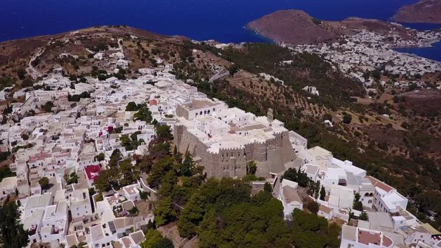 August 2017: Aerial drone video of iconic monastery and medieval castle of Saint John the Theologian with views to chora village, port of Skala and entire Patmos island, Dodecanese, Greece