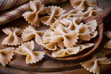 Wholemeal or whole grain farfalle pasta closeup