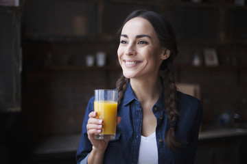 Morning fresh juice from orange in girl hand