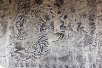 Khmer art in Angkor complex. A close-up image of a beautiful vintage relief composition on the wall of a temple in Cambodia.