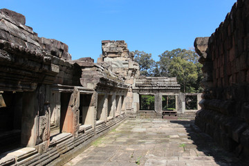 Fototapeta premium Ruins and walls of an ancient city in Angkor complex, near the ancient capital of Cambodia - Siem Reap