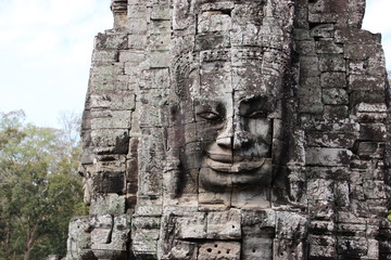 The ruins of an old temple with stone heads and faces in Cambodia