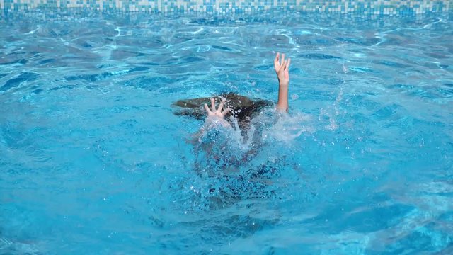 The child is drowning in the water. 4k, slow motion