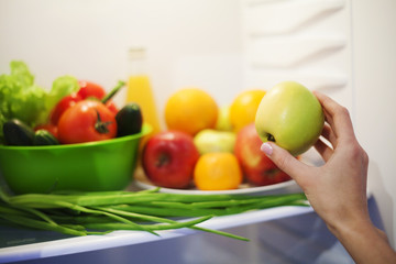 Summer vegetables and fruits in white refrigerator