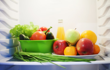 Summer vegetables and fruits in white refrigerator