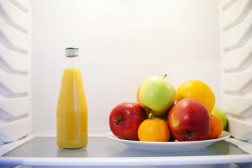 Summer vegetables and fruits in white refrigerator