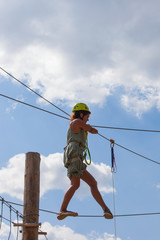 young woman in adventure park summer challenge