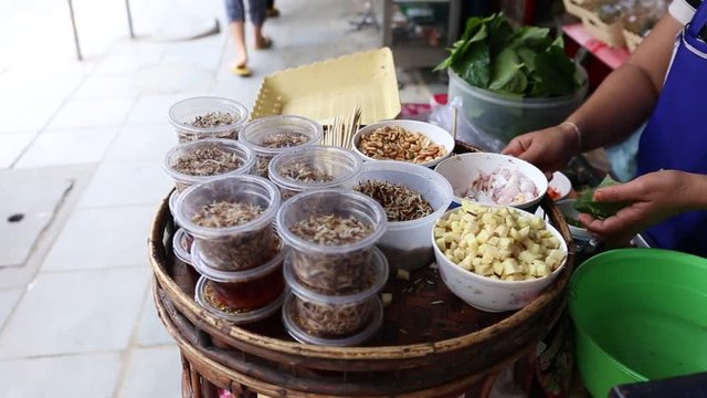 Footage of Local seller make Thai Fresh Leaf Wrapped Bite Size Appetizer, Miang Kham at Bangrak, Bangkok, Thailand