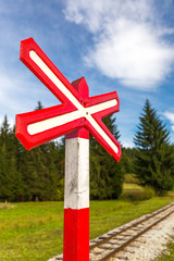 Sign of railroad crossing of a single-track forest railway.
