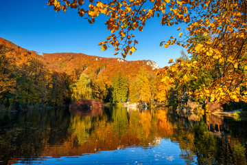 Fototapeta na wymiar Park with a lake in autumn colors in the spa town Rajecke Teplice in Slovakia, Europe.